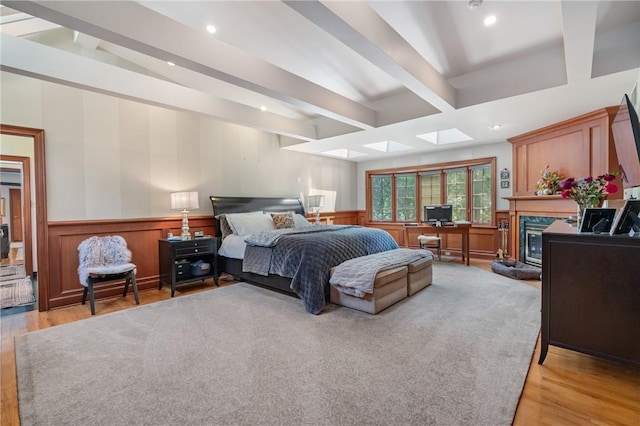 337 Fox Chapel Rd, Fox Chapel, PA 15238 - bedroom featuring beamed ceiling, a skylight, light wood-style floors, a high end fireplace, and recessed lighting