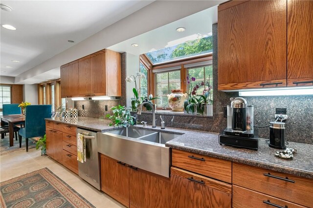 337 Fox Chapel Rd, Fox Chapel, PA 15238 - kitchen featuring stainless steel dishwasher, brown cabinets, dark stone countertops, decorative backsplash, and recessed lighting
