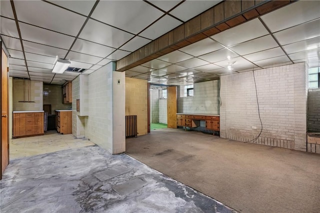 1518 Carlisle St, Natrona Hts/Harrison Twp, PA 15065 - basement featuring a paneled ceiling, radiator, and brick wall
