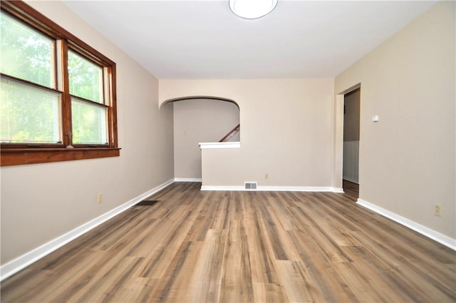 312 Delmont Ave, Coolbaugh Twp, PA 15012 - spare room with arched walkways and wood finished floors