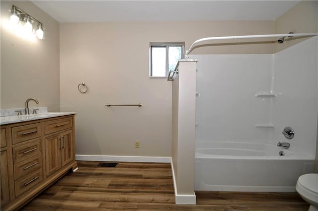 312 Delmont Ave, Coolbaugh Twp, PA 15012 - bathroom with wood finished floors, shower / tub combination, and vanity