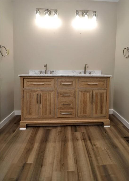 312 Delmont Ave, Coolbaugh Twp, PA 15012 - bathroom with double vanity and wood finished floors