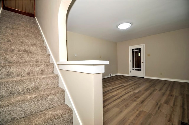 312 Delmont Ave, Coolbaugh Twp, PA 15012 - stairs featuring wood finished floors and arched walkways