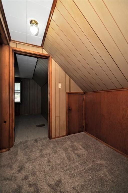 312 Delmont Ave, Coolbaugh Twp, PA 15012 - bonus room with carpet flooring, vaulted ceiling, and wood walls