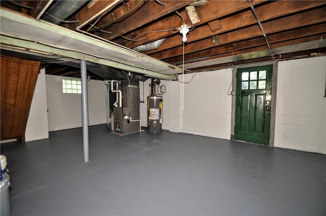 312 Delmont Ave, Coolbaugh Twp, PA 15012 - below grade area with heating unit, gas water heater, plenty of natural light, and concrete block wall