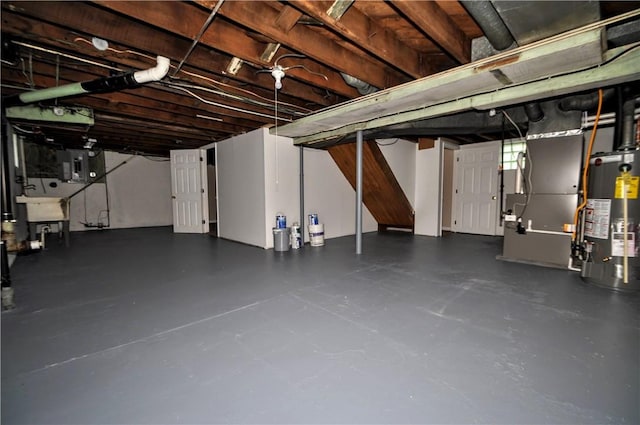 312 Delmont Ave, Coolbaugh Twp, PA 15012 - unfinished basement featuring gas water heater, electric panel, and heating unit
