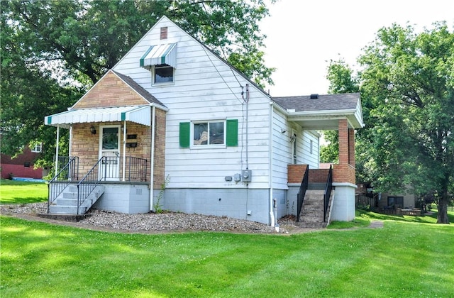 312 Delmont Ave, Coolbaugh Twp, PA 15012 - view of front of home featuring a front lawn and a shingled roof