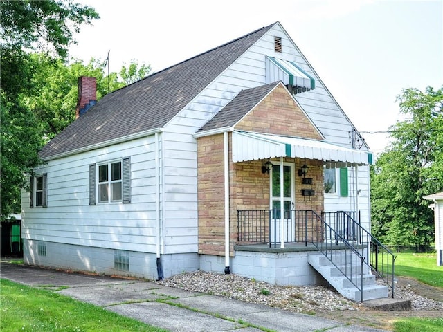 312 Delmont Ave, Coolbaugh Twp, PA 15012 - bungalow-style house featuring a chimney, roof with shingles, and stone siding
