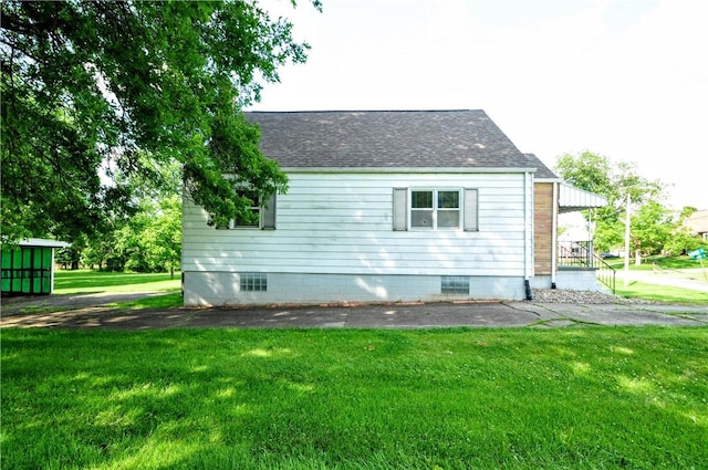 312 Delmont Ave, Coolbaugh Twp, PA 15012 - view of side of property featuring a lawn and a shingled roof