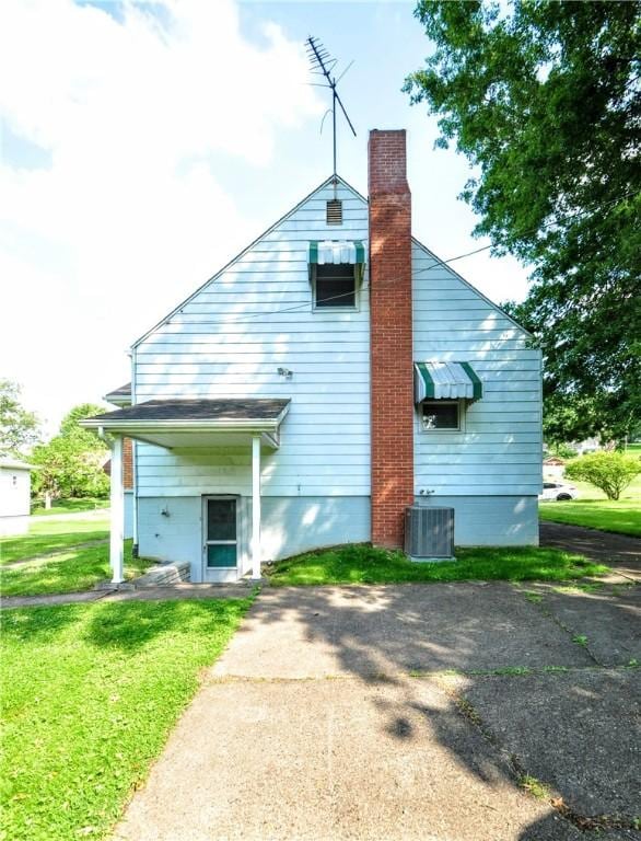 312 Delmont Ave, Coolbaugh Twp, PA 15012 - back of house with a chimney and a yard
