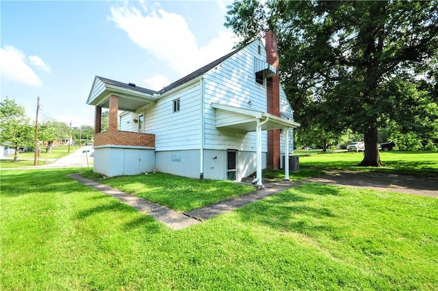 312 Delmont Ave, Coolbaugh Twp, PA 15012 - view of property exterior featuring a chimney and a yard