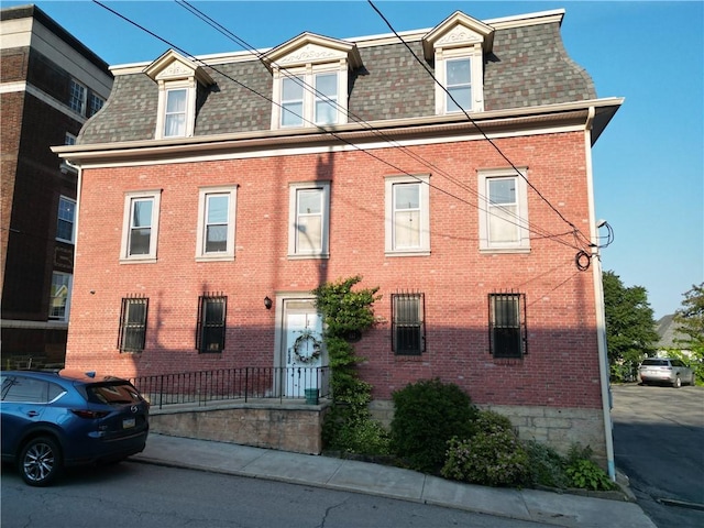 117 S Mckean St, City Of But Ne, PA 16001 - second empire-style home featuring roof with shingles, mansard roof, and brick siding