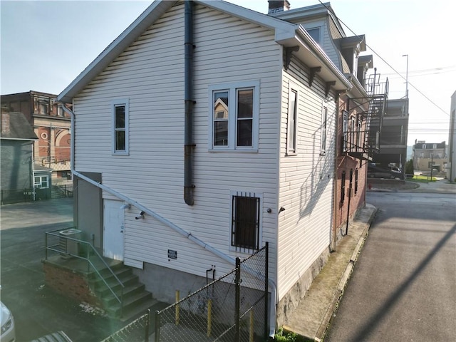 117 S Mckean St, City Of But Ne, PA 16001 - rear view of house with stairs, a chimney, and crawl space
