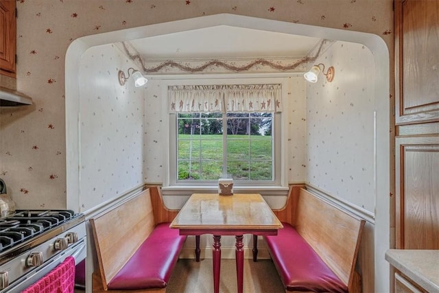 2509 Ridge Rd, Jefferson Hills, PA 15332 - dining space with wallpapered walls, arched walkways, and a wainscoted wall