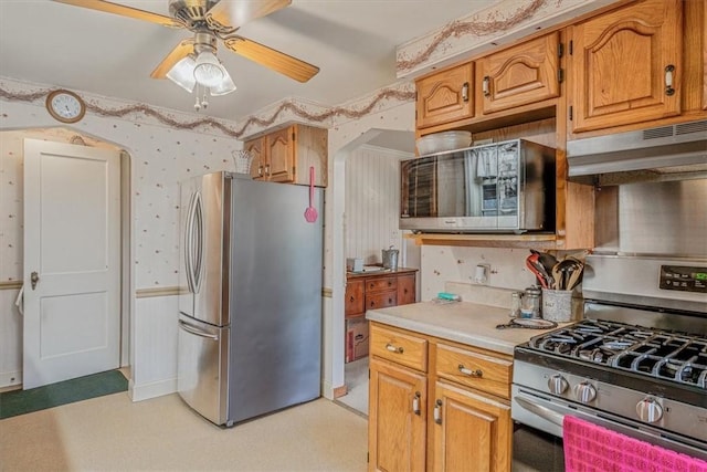 2509 Ridge Rd, Jefferson Hills, PA 15332 - kitchen featuring stainless steel appliances, under cabinet range hood, wallpapered walls, ceiling fan, and light countertops