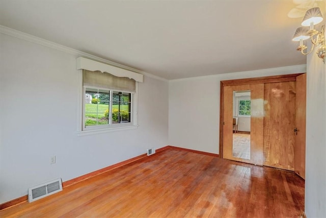2509 Ridge Rd, Jefferson Hills, PA 15332 - spare room featuring wood finished floors, crown molding, and a chandelier