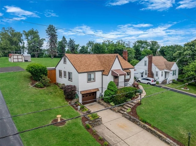2509 Ridge Rd, Jefferson Hills, PA 15332 - view of front of home with concrete driveway, a garage, a chimney, a shingled roof, and a storage shed