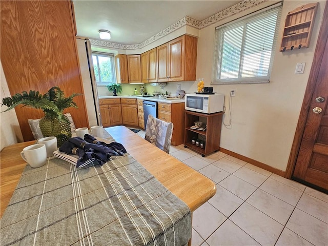 468 Lois Dr, Baldwin Boro, PA 15236 - kitchen with white microwave, dishwashing machine, light countertops, light tile patterned floors, and freestanding refrigerator
