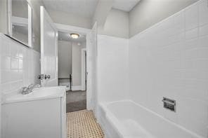 10207 Frankstown Rd, Penn Hills, PA 15235 - full bathroom with vanity and shower / tub combination