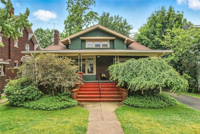 946 Alcoma St, Sharon, PA 16146 - view of front of home featuring covered porch, a chimney, and a front lawn