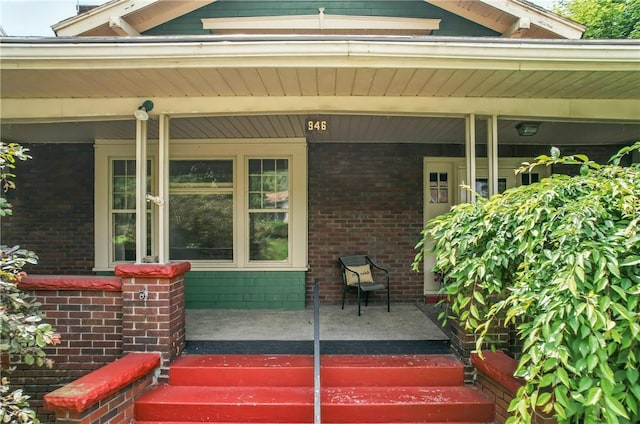 946 Alcoma St, Sharon, PA 16146 - doorway to property with a porch and brick siding