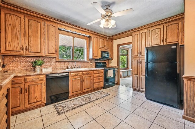 946 Alcoma St, Sharon, PA 16146 - kitchen with black appliances, a ceiling fan, brown cabinets, decorative backsplash, and light tile patterned floors