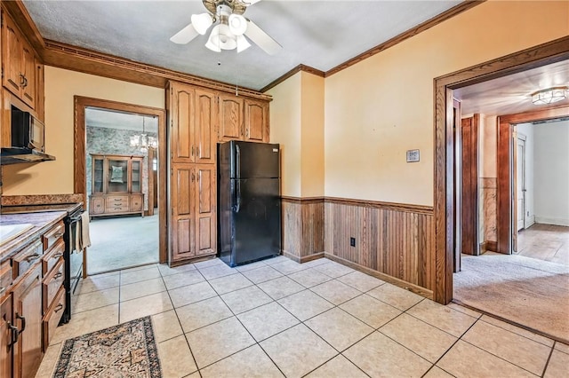 946 Alcoma St, Sharon, PA 16146 - kitchen with black appliances, crown molding, a ceiling fan, light colored carpet, and wainscoting