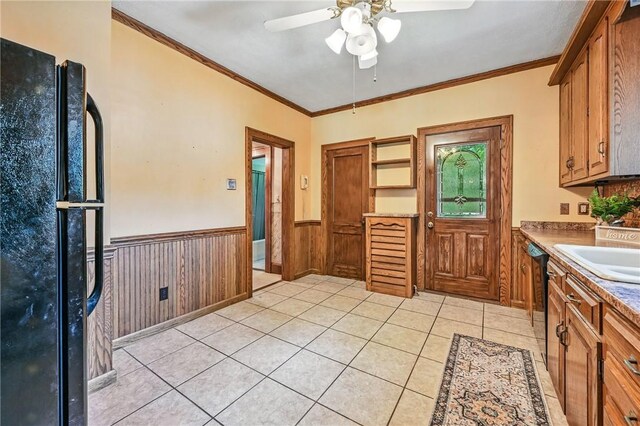 946 Alcoma St, Sharon, PA 16146 - kitchen featuring freestanding refrigerator, wainscoting, ceiling fan, light tile patterned floors, and brown cabinets
