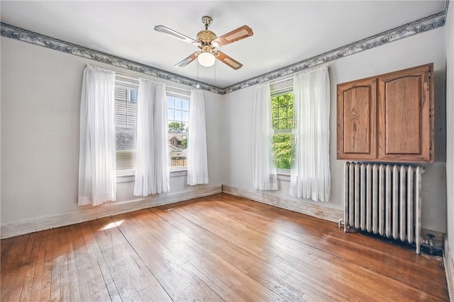 946 Alcoma St, Sharon, PA 16146 - spare room with radiator heating unit, hardwood / wood-style floors, and ceiling fan