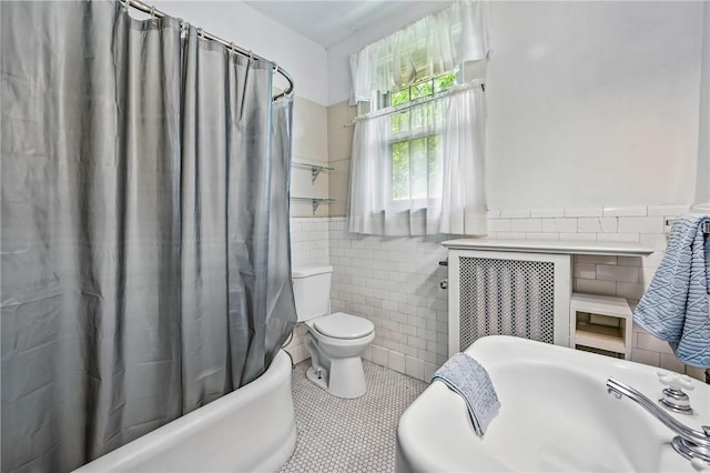946 Alcoma St, Sharon, PA 16146 - full bathroom featuring tile walls, tile patterned flooring, shower / bath combo with shower curtain, and a wainscoted wall