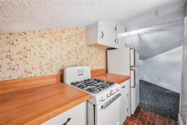 946 Alcoma St, Sharon, PA 16146 - kitchen featuring white appliances, white cabinets, a textured ceiling, brick patterned floors, and wooden counters