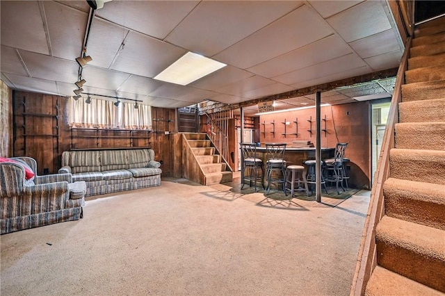 946 Alcoma St, Sharon, PA 16146 - basement featuring stairway, a dry bar, wooden walls, carpet flooring, and healthy amount of natural light