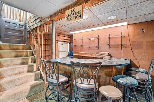 946 Alcoma St, Sharon, PA 16146 - indoor bar with stairway, wood walls, brick patterned floors, and a drop ceiling