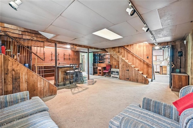 946 Alcoma St, Sharon, PA 16146 - living room with wooden walls, stairway, carpet floors, and track lighting