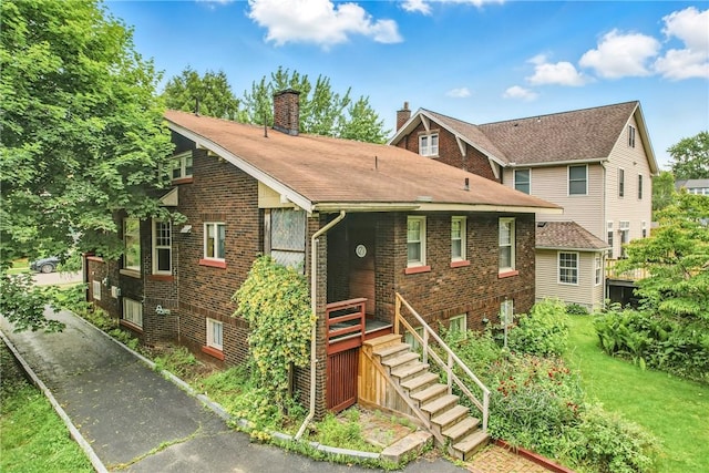 946 Alcoma St, Sharon, PA 16146 - view of front facade with a chimney, brick siding, and stairs