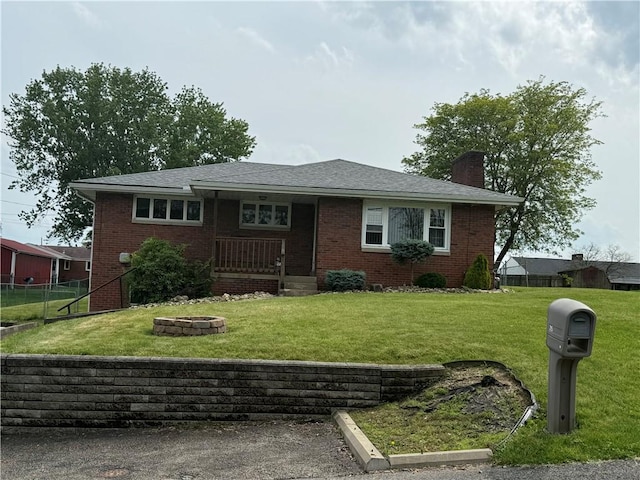 215 Locust Ave, Houston, PA 15342 - view of front facade with a chimney, brick siding, a fire pit, and a porch