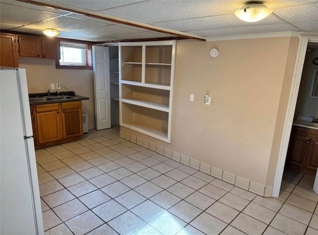 126 N Otter St, Mercer Boro Mer, PA 16137 - kitchen featuring freestanding refrigerator, light tile patterned floors, brown cabinets, dark countertops, and crown molding