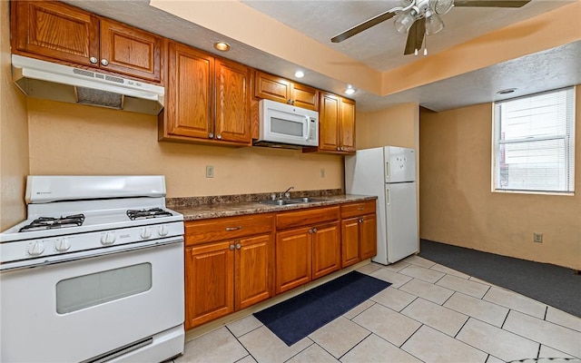 720 Evergreen Ave, Millvale, PA 15209 - kitchen with white appliances, under cabinet range hood, brown cabinets, ceiling fan, and dark countertops