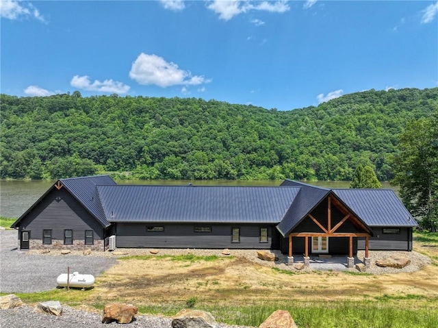 1060 Wattersonville Rd, Coolbaugh Twp, PA 16218 - rear view of property with a forest view and a metal roof
