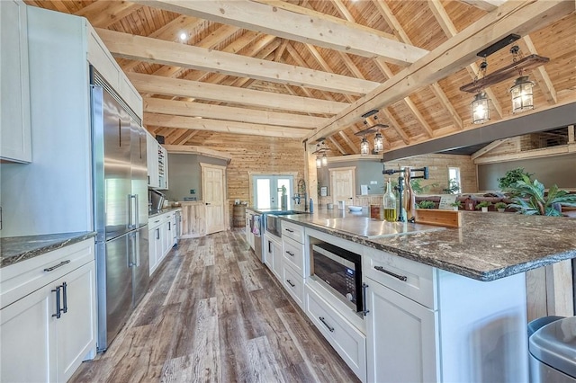 1060 Wattersonville Rd, Coolbaugh Twp, PA 16218 - kitchen with a wood ceiling with exposed beams, built in appliances, wood finished floors, white cabinets, and a spacious island