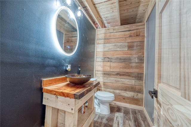 1060 Wattersonville Rd, Coolbaugh Twp, PA 16218 - bathroom featuring wood finished floors, wood ceiling, wooden walls, vanity, and a textured wall