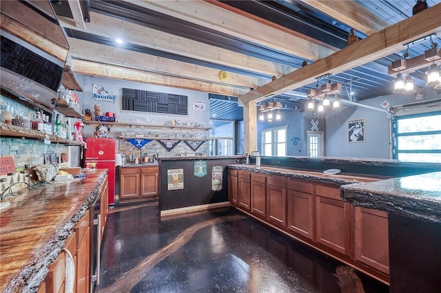 1060 Wattersonville Rd, Coolbaugh Twp, PA 16218 - kitchen featuring brown cabinetry and dark stone counters