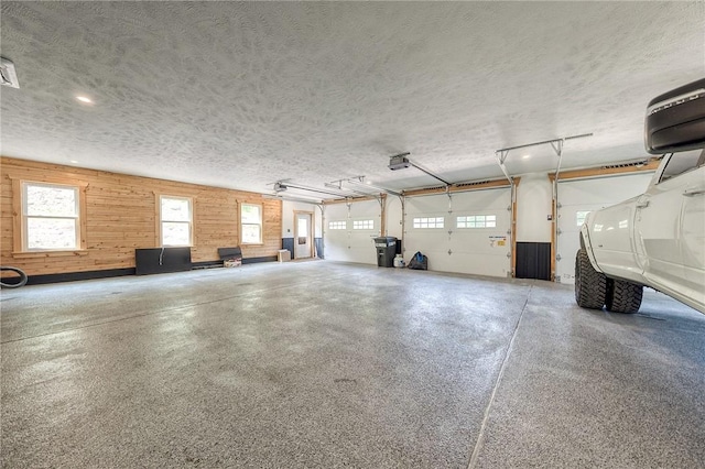 1060 Wattersonville Rd, Coolbaugh Twp, PA 16218 - garage featuring wood walls, recessed lighting, and a garage door opener