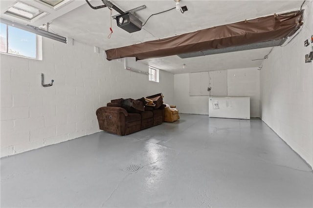 433 Wyndhurst Dr, Moon/Crescent Twp, PA 15108 - garage with a garage door opener, concrete block wall, and freestanding refrigerator