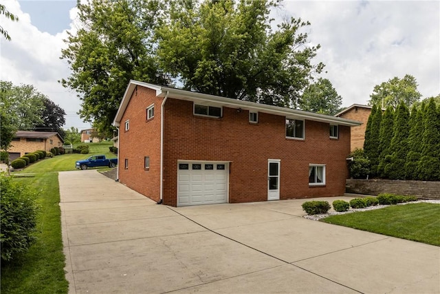 433 Wyndhurst Dr, Moon/Crescent Twp, PA 15108 - view of home's exterior featuring concrete driveway, a garage, a lawn, and brick siding