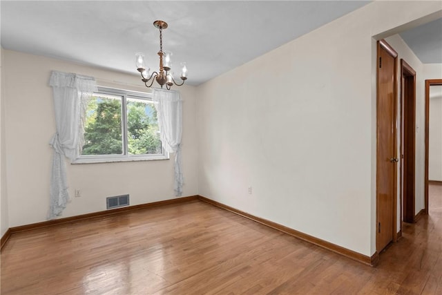 433 Wyndhurst Dr, Moon/Crescent Twp, PA 15108 - empty room featuring a chandelier and wood finished floors