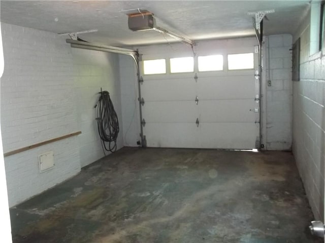 243 Byron Rd, Ross Twp, PA 15237 - garage featuring a garage door opener and concrete block wall