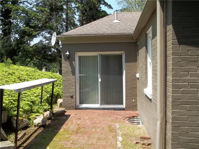 243 Byron Rd, Ross Twp, PA 15237 - property entrance featuring brick siding, a patio area, and a shingled roof