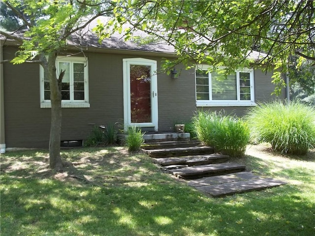 243 Byron Rd, Ross Twp, PA 15237 - view of exterior entry featuring a lawn and roof with shingles