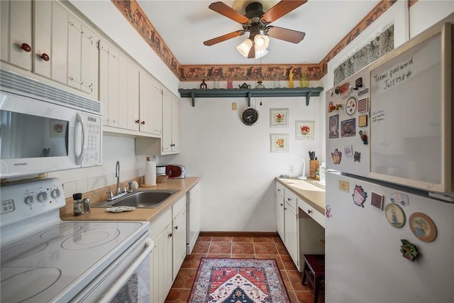 225 E Swissvale Ave Unit 2, Edgewood, PA 15218 - kitchen with white appliances, light countertops, ceiling fan, and white cabinetry